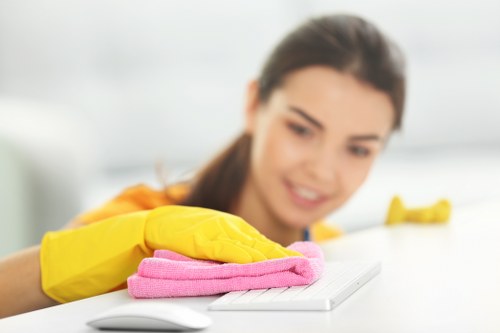 Supervisor reviewing health and safety procedures with a cleaner